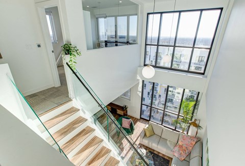 A living room with a couch and a glass table.